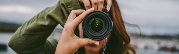 Young-woman-using-DSLR-camera